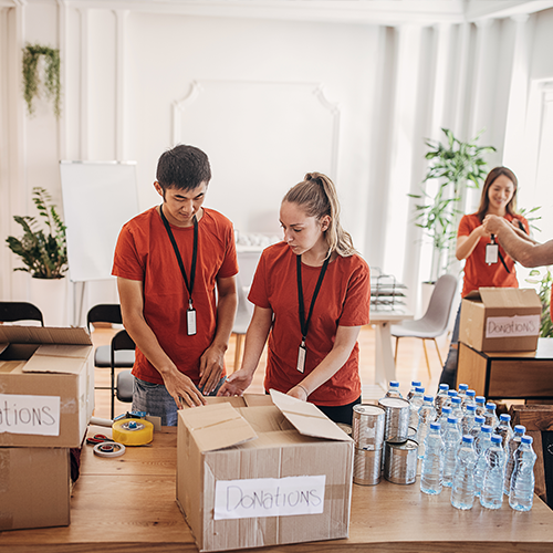 Young couple packing donation boxes